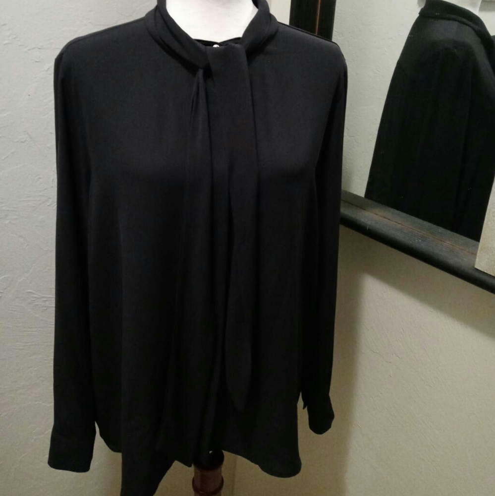 Black polyester blouse with a tie.
